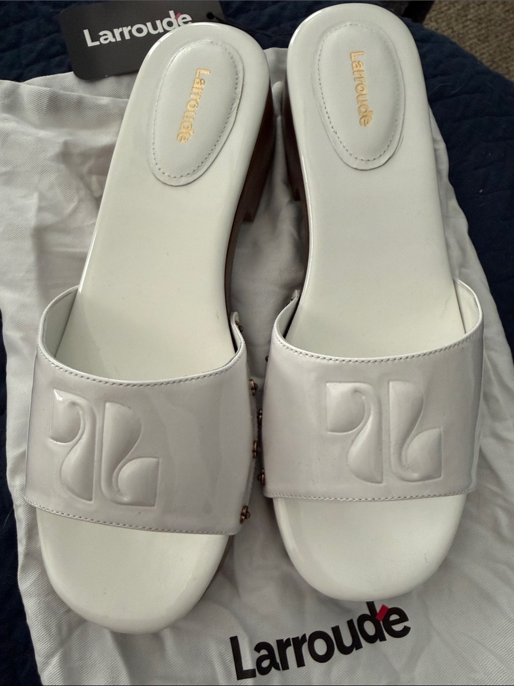 Larroude White Patent Slide Mules with Embossed Logo